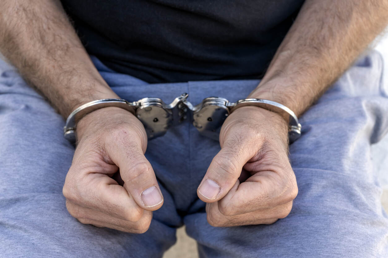 person with hand cuffs