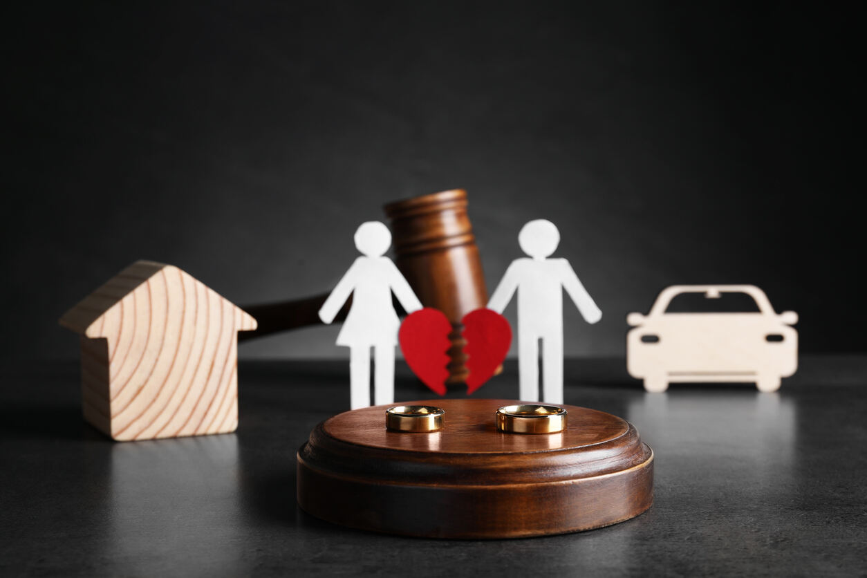 wooden and paper figures showing the concept of divorce .