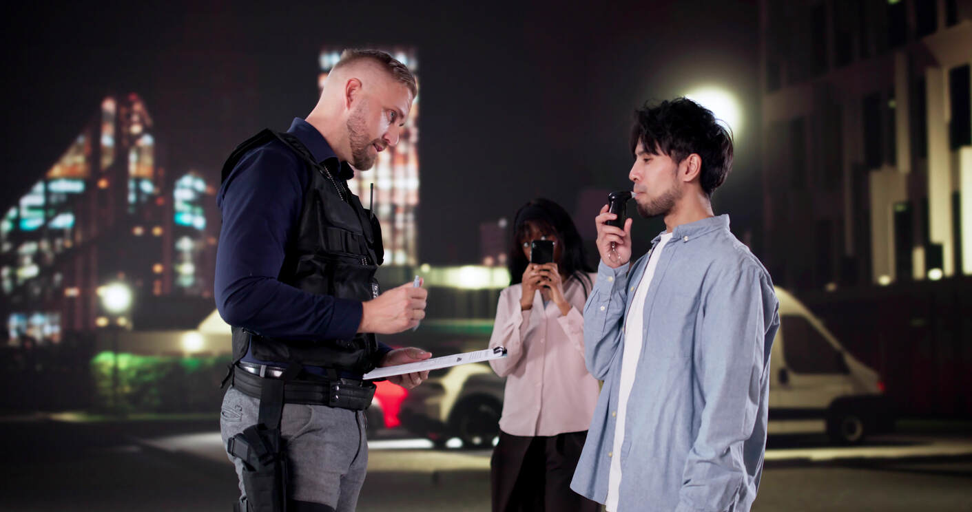 Police Officer Conducts Breathalyzer Test During Traffic Stop